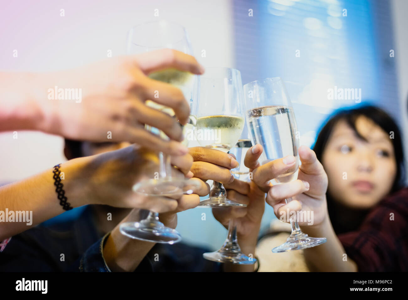 Asian group of friends having party with alcoholic beer drinks and Young people enjoying at a bar toasting cocktails.soft focus Stock Photo