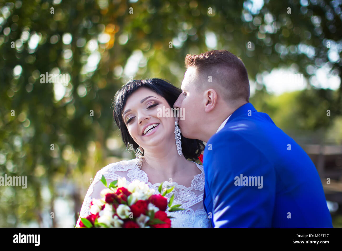 Belarus, Gomel, September 29, 2017, Wedding Feast.The bridegroom is a kisser to the bride. Bride and groom. Happy bride and kissing groom Stock Photo