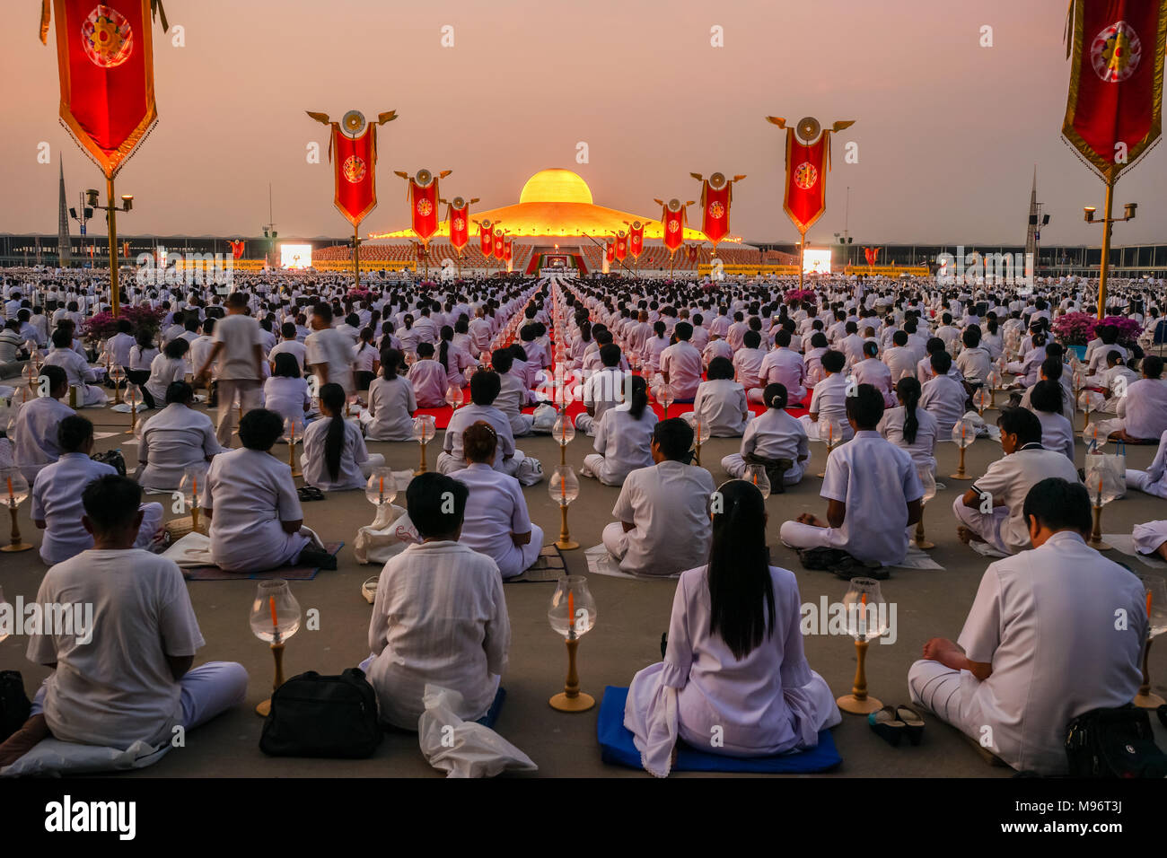 Pathumthani, Thailand - March 4, 2015: Many Buddhists doing meditation in front of Dhammakaya Cetiya in Dhammakaya temple of Pathumthani, Thailand Stock Photo