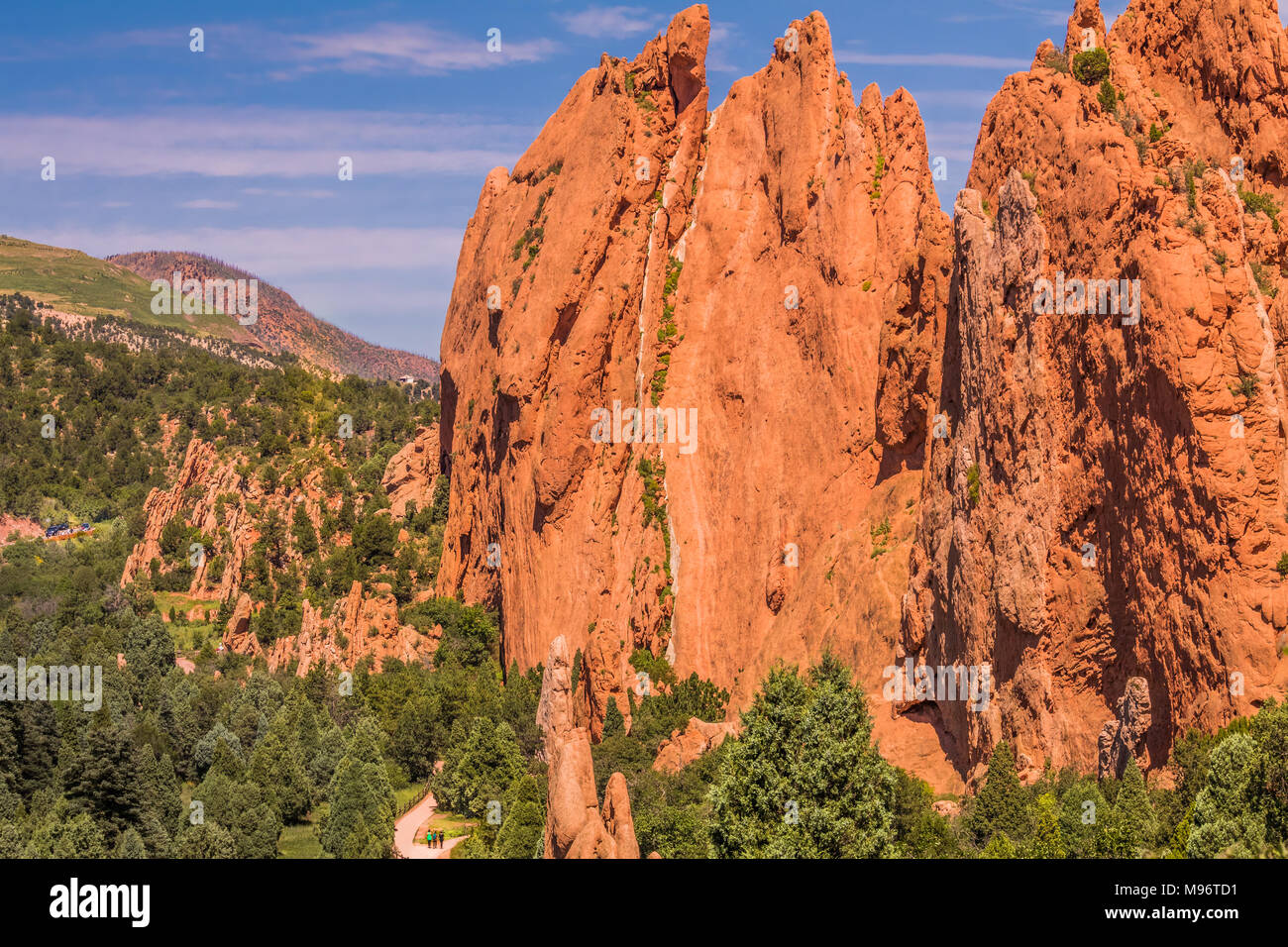 View of whimsical rock formations in Garden of the Gods park, Colorado Springs, Colorado; on the bottom, tiny figures of people walking on the ground Stock Photo