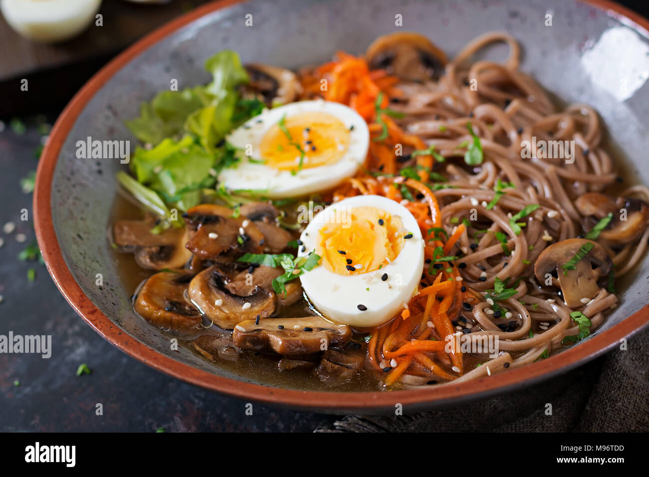 Japanese miso ramen noodles with eggs, carrot and mushrooms. Soup delicious food. Stock Photo