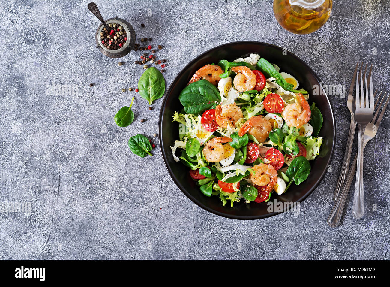 Healthy salad plate. Fresh seafood recipe. Grilled shrimps and fresh vegetable salad and egg. Grilled prawns. Healthy food. Flat lay. Top view Stock Photo