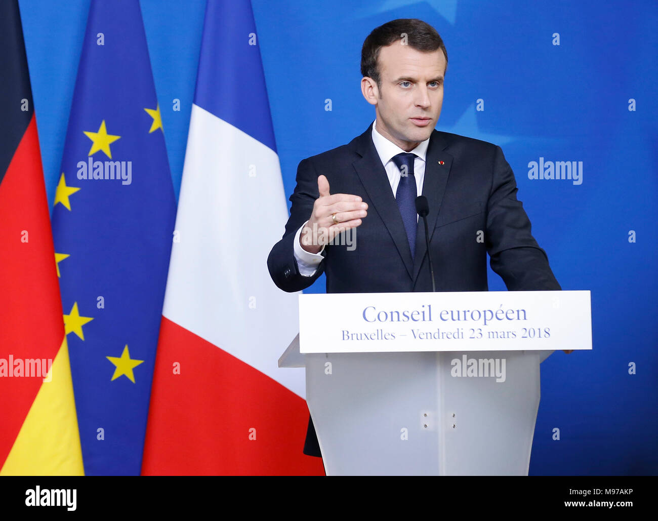 Brussels, Belgium. 23rd Mar, 2018. France's President Emmanuel Macron attends a news conference with Germany's Chancellor Angela Merkel (not seen) after the spring EU Summit at EU headquarters in Brussels, Belgium, early on March 23, 2018. Credit: Ye Pingfan/Xinhua/Alamy Live News Stock Photo