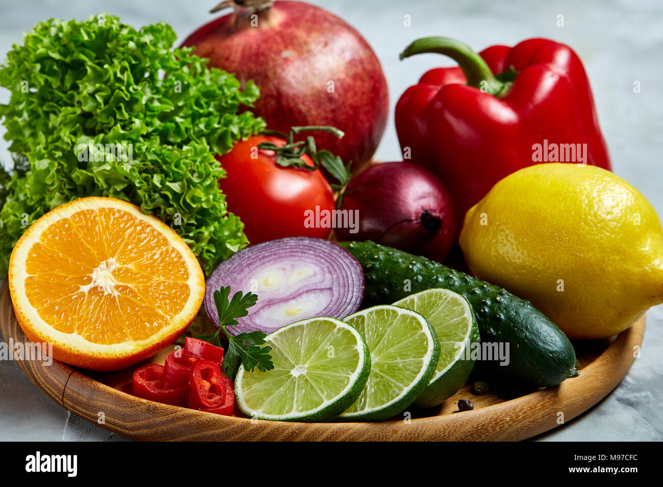 Colorful still life of fresh organic fruits and vegetables on wooden ...