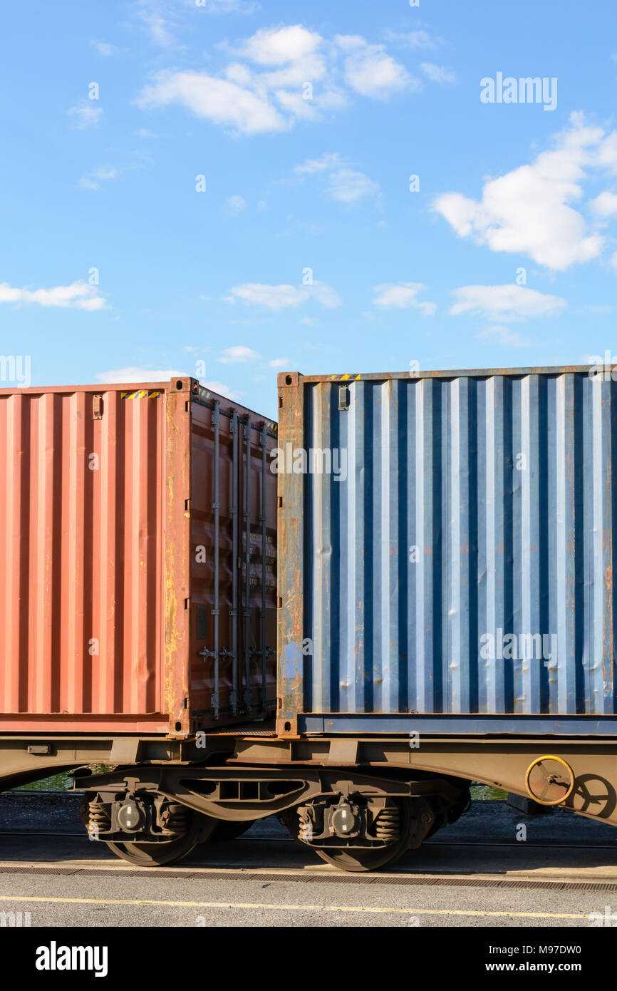Two containers on a flat car train parked in a shipping yard in the ...