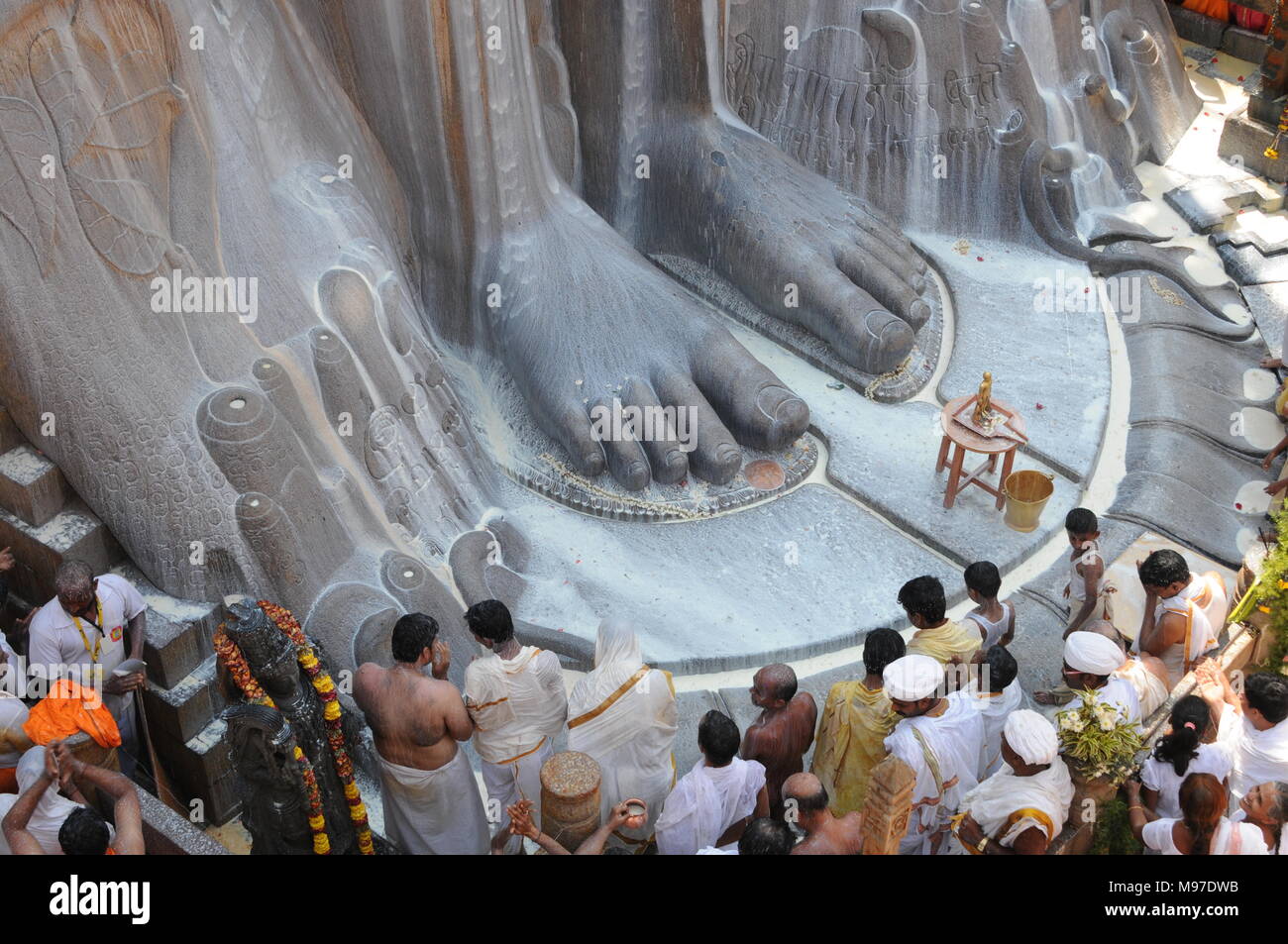Jain devotees at the foot of gomateshvara bahubali statue