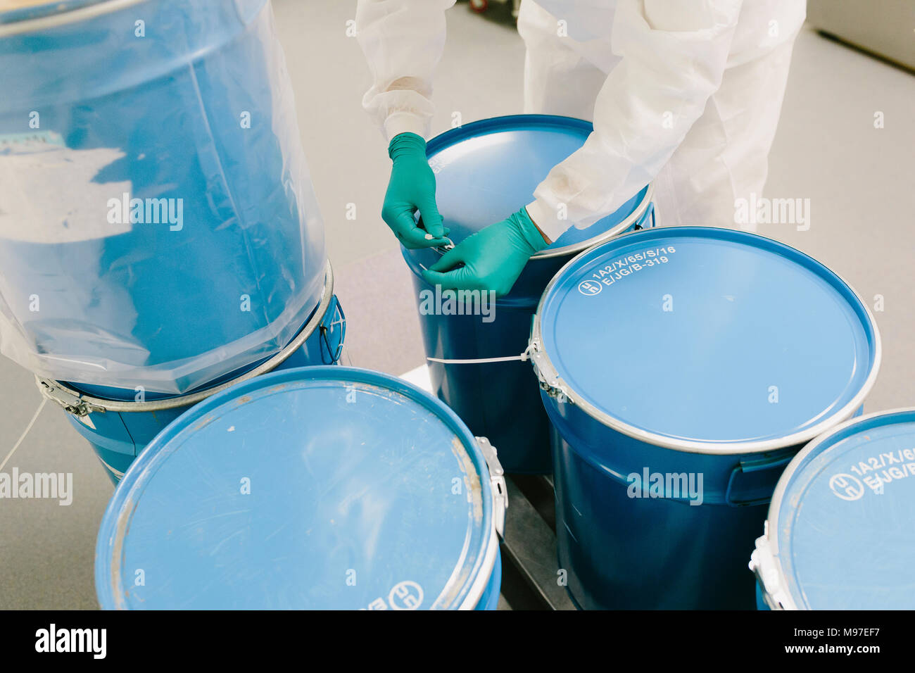 Man manipulating barrels in a pharmaceutical industry Stock Photo