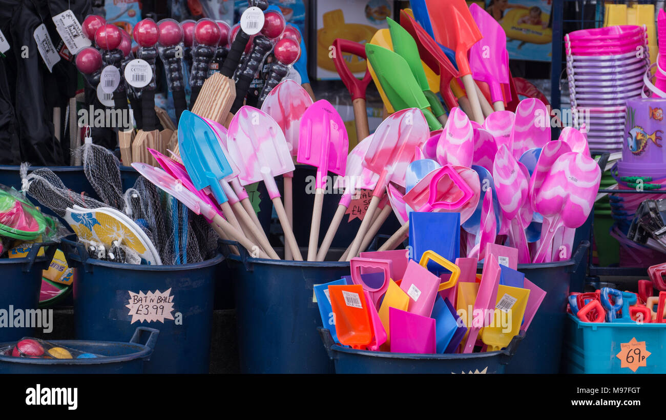 Buckets and spades and other plastic toys for sale in a British beach front shop, Padstow, Cornwall, U.K. Stock Photo