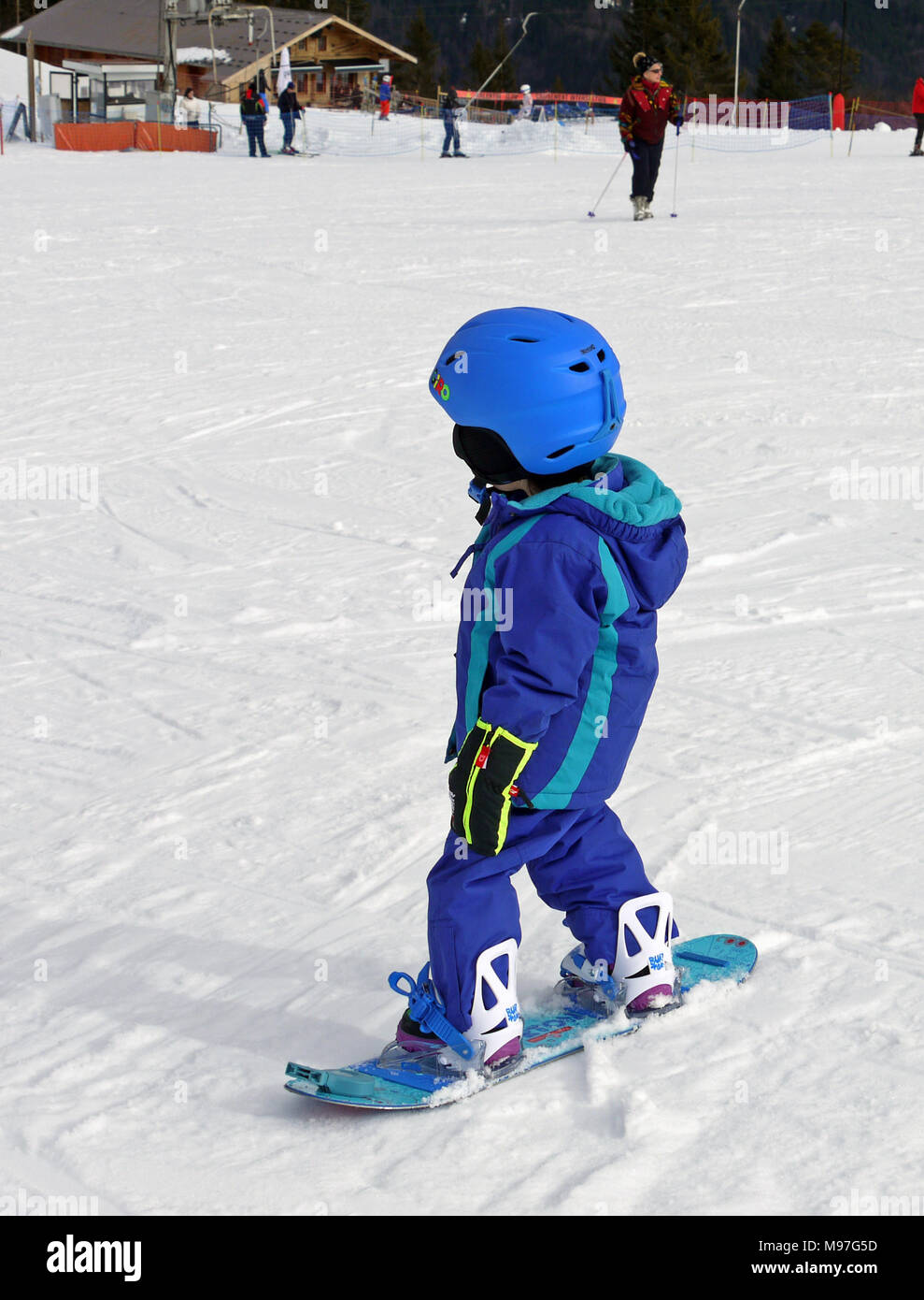 young child on a snowboard in the family resort of La Grande Terche, above St Jean D'Aulps Stock Photo