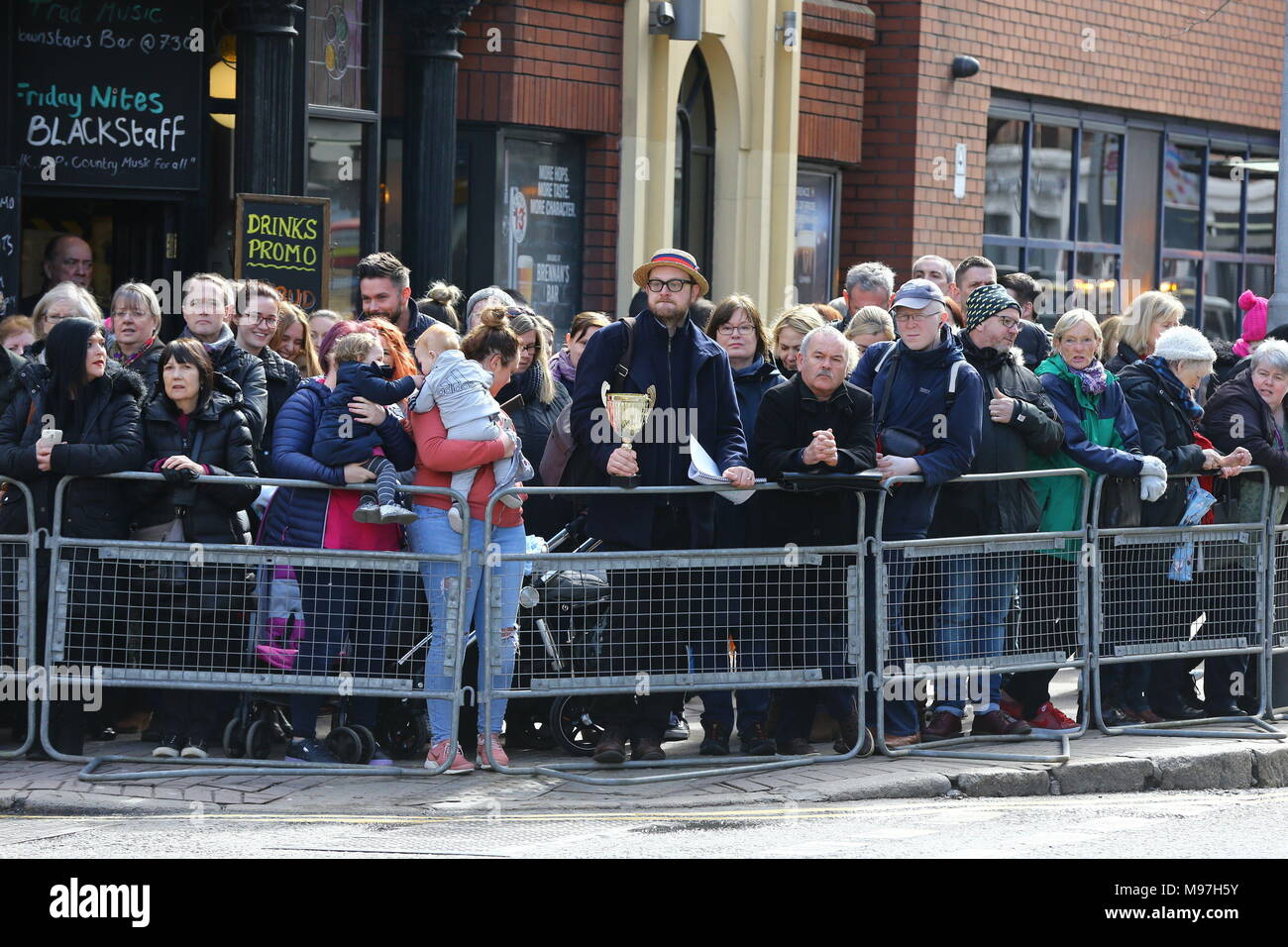 Crowds wait for Prince Harry and Meghan Markle to arrive for a walkabout in Belfast City centre where they will visit the Crown Bar and learn from National Trust representatives about the pub's heritage, and meet bar staff, local comedians and musicians. Stock Photo