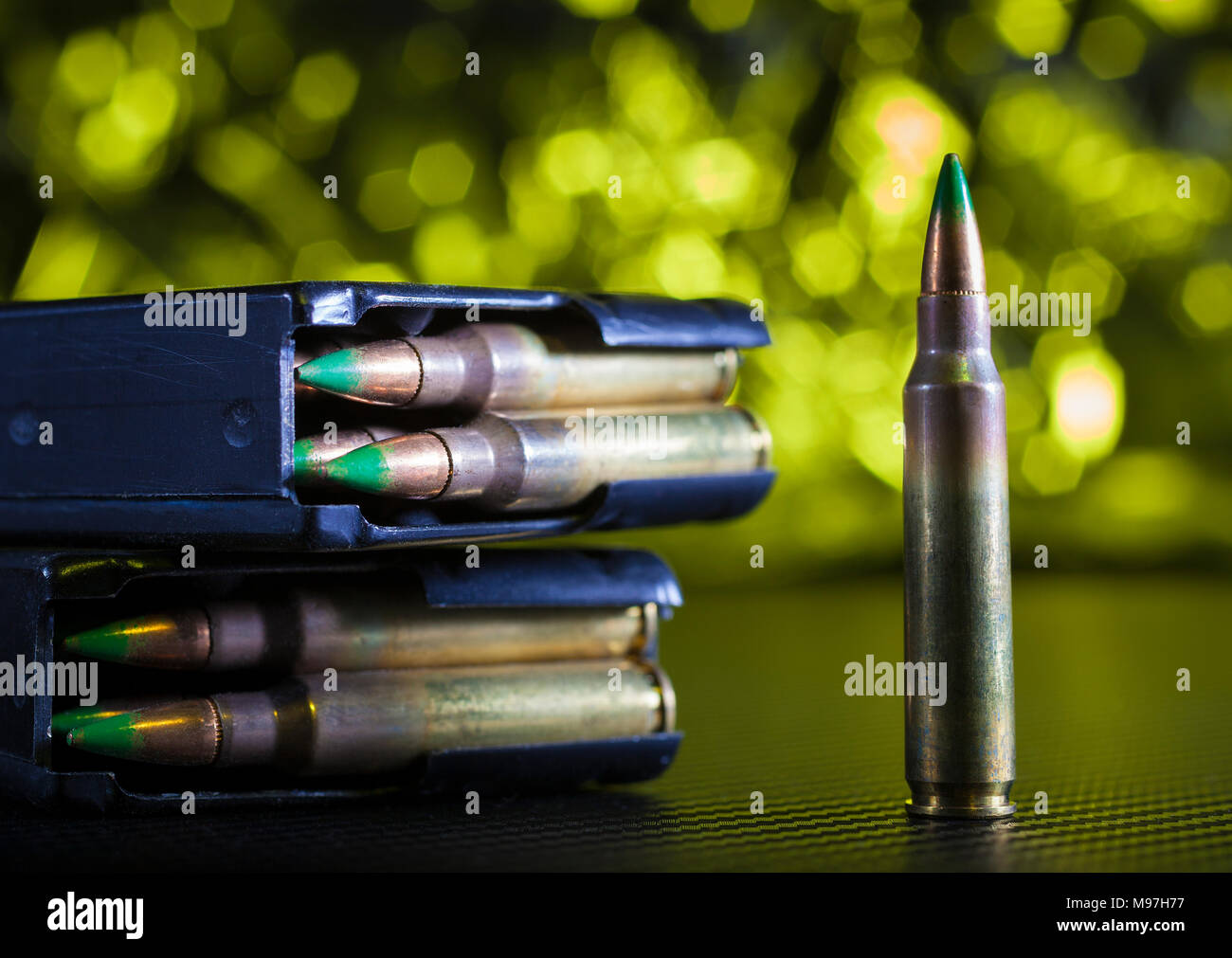 M855 military ammunition with metal magazines and yellow background