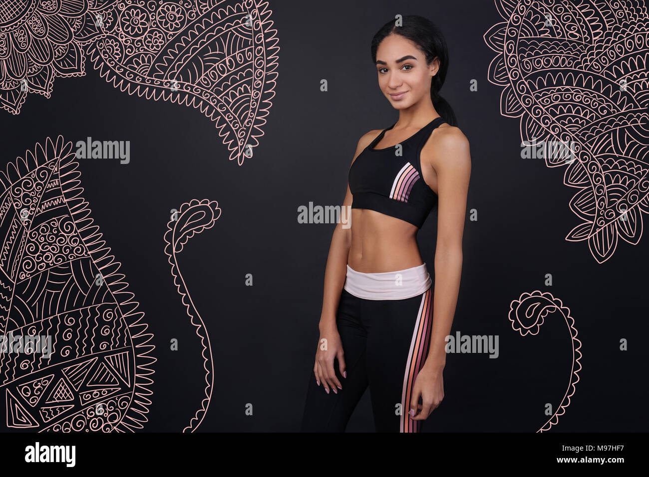 Beautiful girl showing her good shape while wearing sports clothes ...