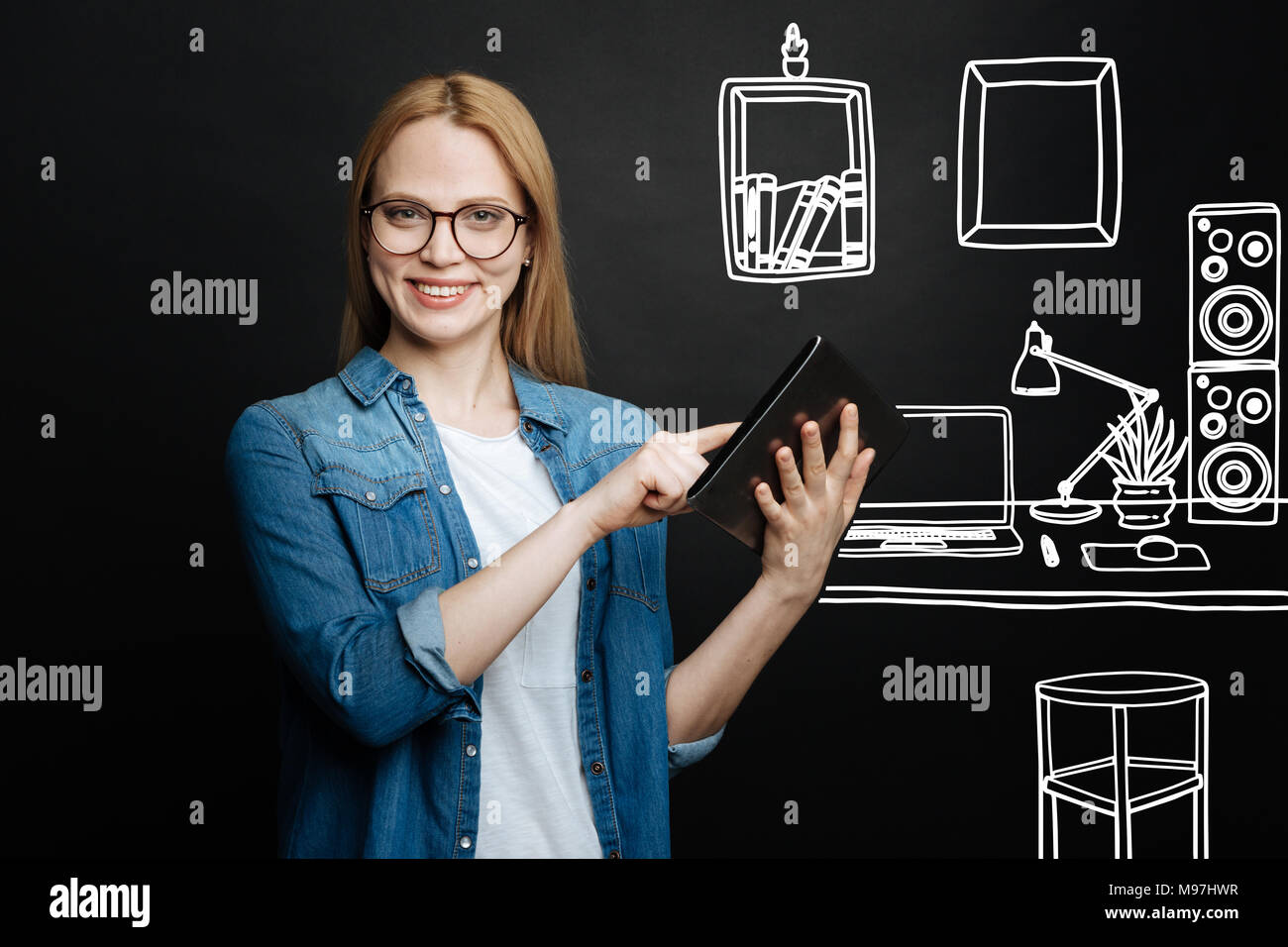 Clever student holding a modern tablet and feeling confident Stock Photo