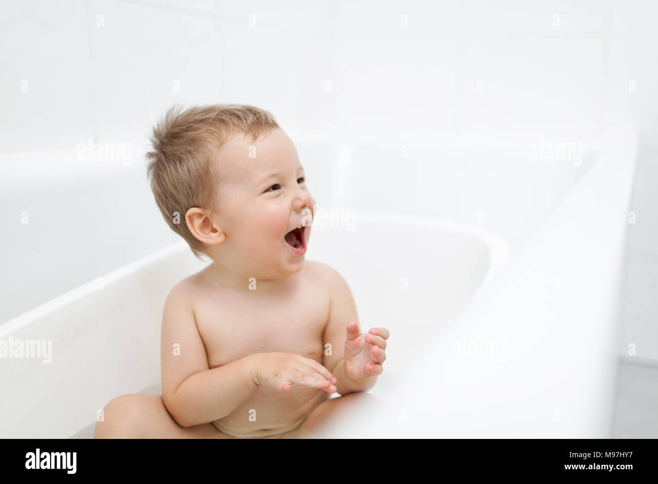Adorable young toddler in the bathroom having a bath Stock Photo Alamy