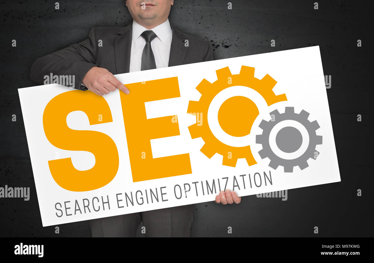 SEO poster is held by businessman. Stock Photo