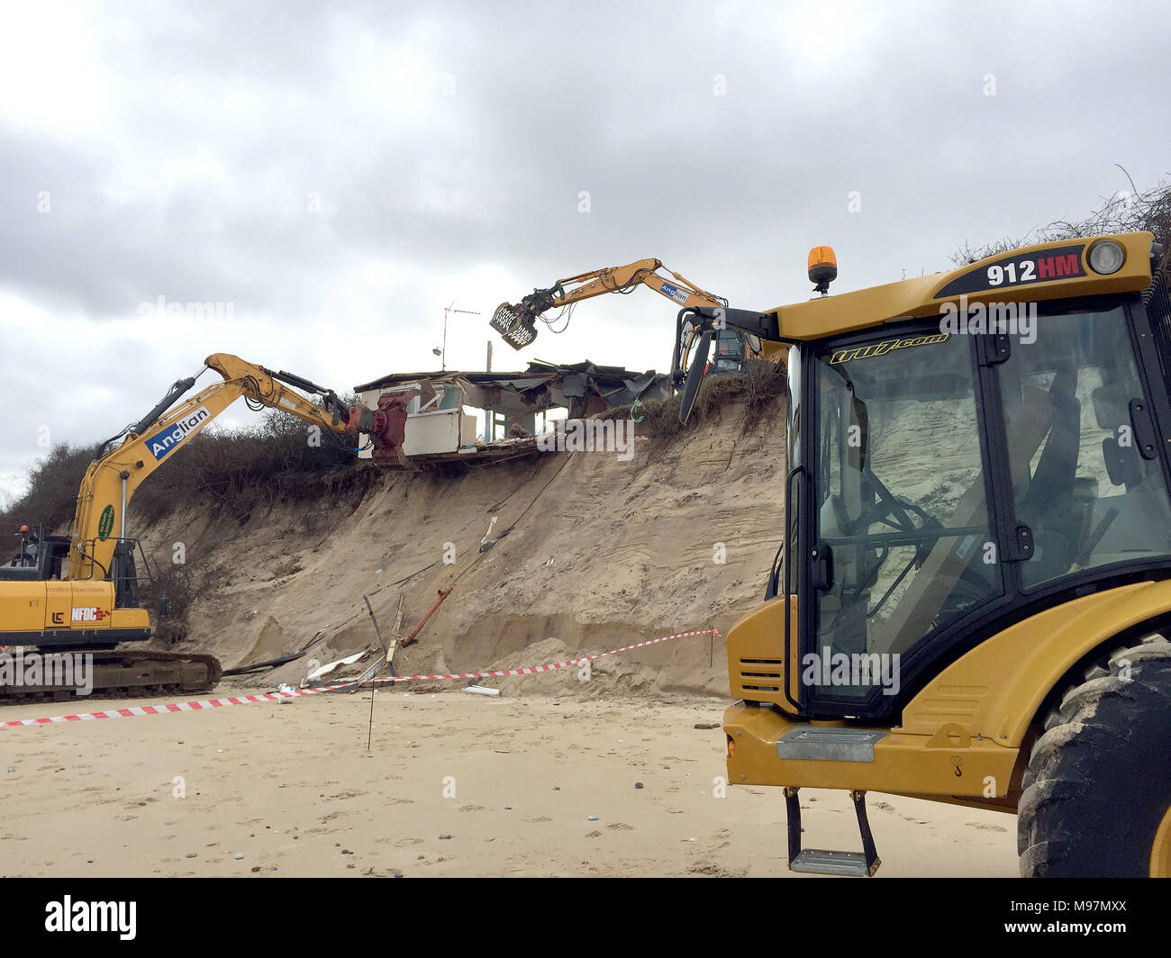 A home teetering on the edge of a cliff being demolished in Hemsby ...