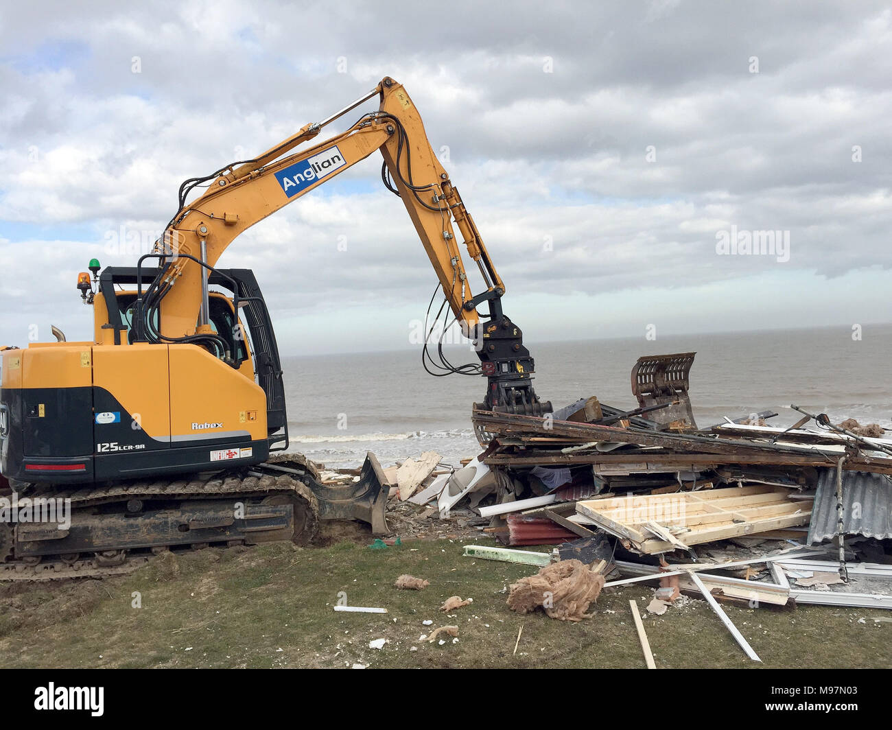 A home teetering on the edge of a cliff being demolished in Hemsby ...