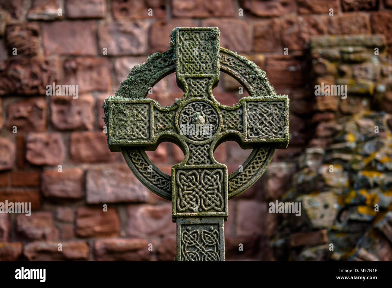 A high Celtic cross in a graveyard in the Glendalough Monastic site Stock Photo