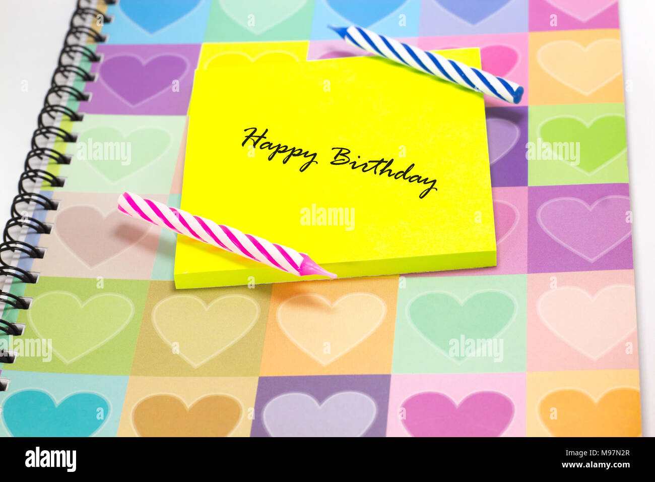 Happy birthday candle and notepad with love diary background Stock Photo