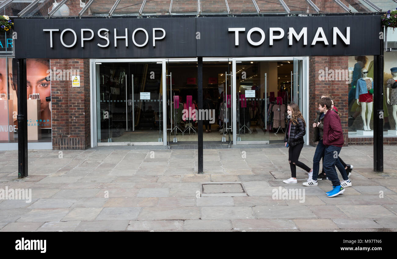 YORK, UK - MARCH 23, 2018. A group of teenagers walking past the front of the clothing store Topman and  which is owned by the Arcadia Group. Stock Photo