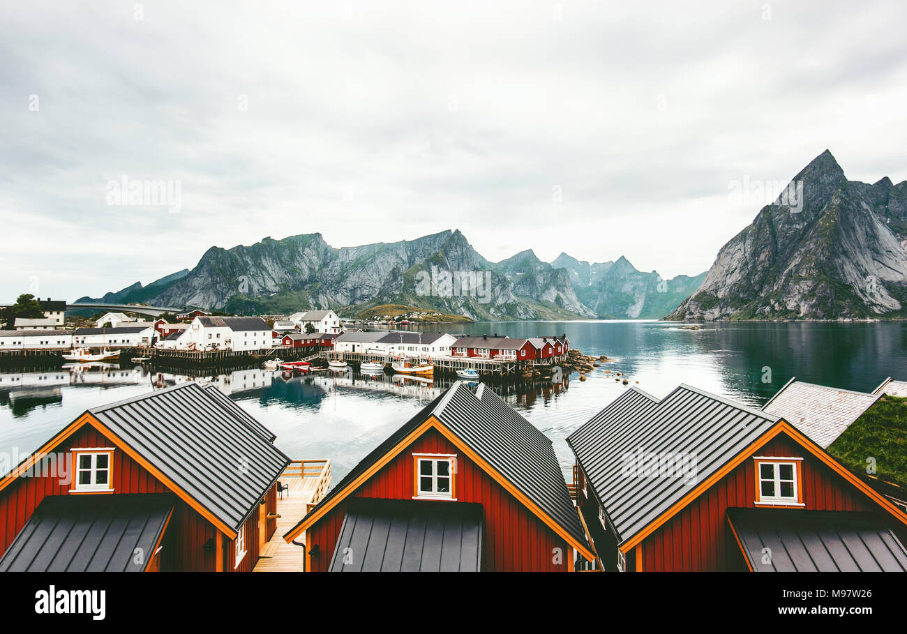 Norway village traditional houses roofs and mountain rocks over fjord ...