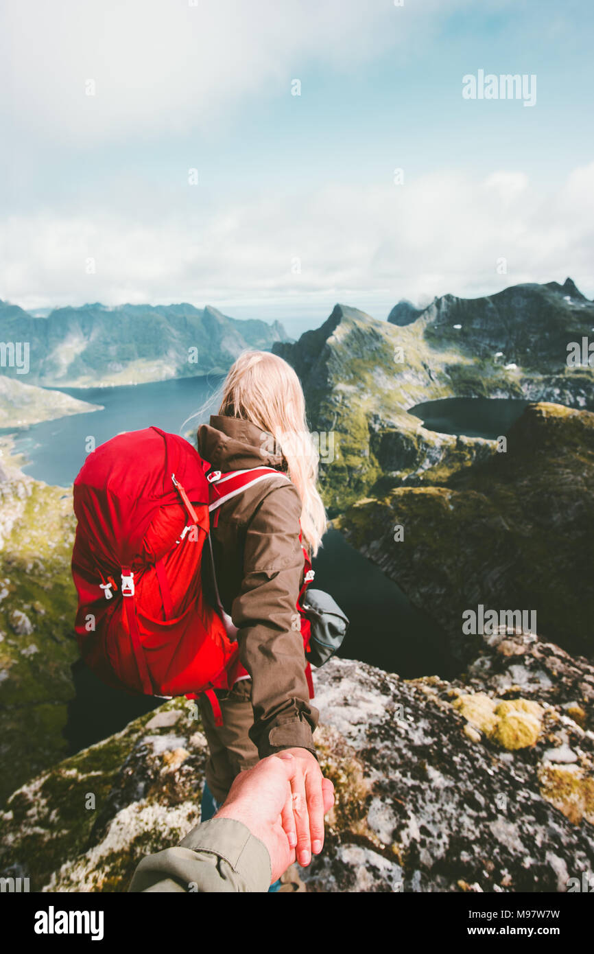 Follow hands holding couple hiking in mountains Travel Lifestyle adventure vacations concept wanderlust together Stock Photo