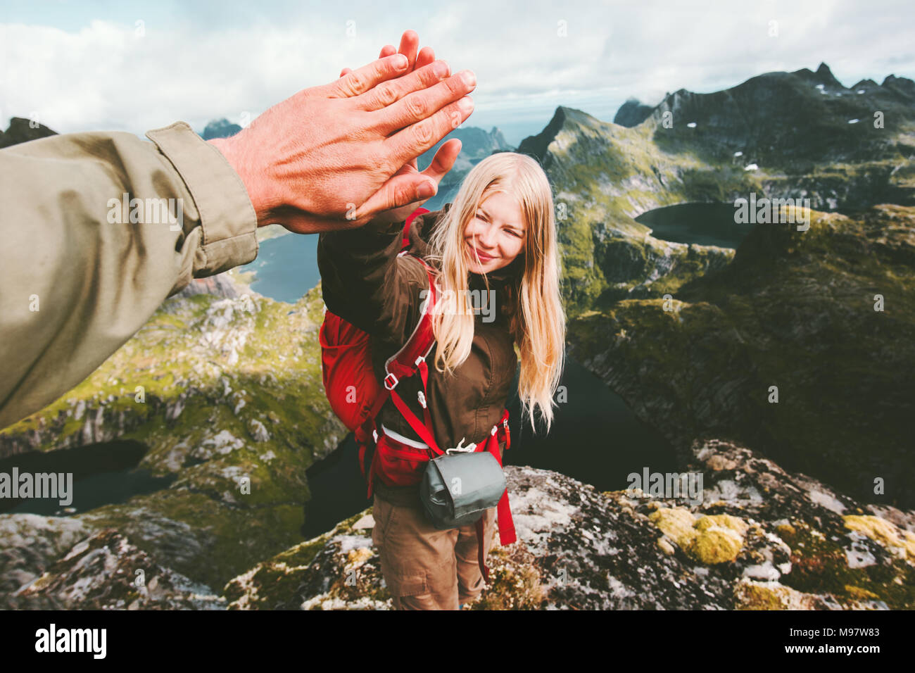 Couple friends giving five hands reached mountain top Travel Lifestyle success emotions concept family travelers together spending active adventure va Stock Photo
