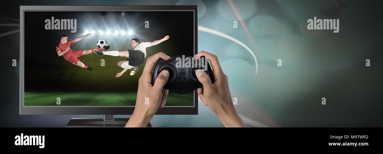 Playing soccer computer game with controller in hands Stock Photo - Alamy
