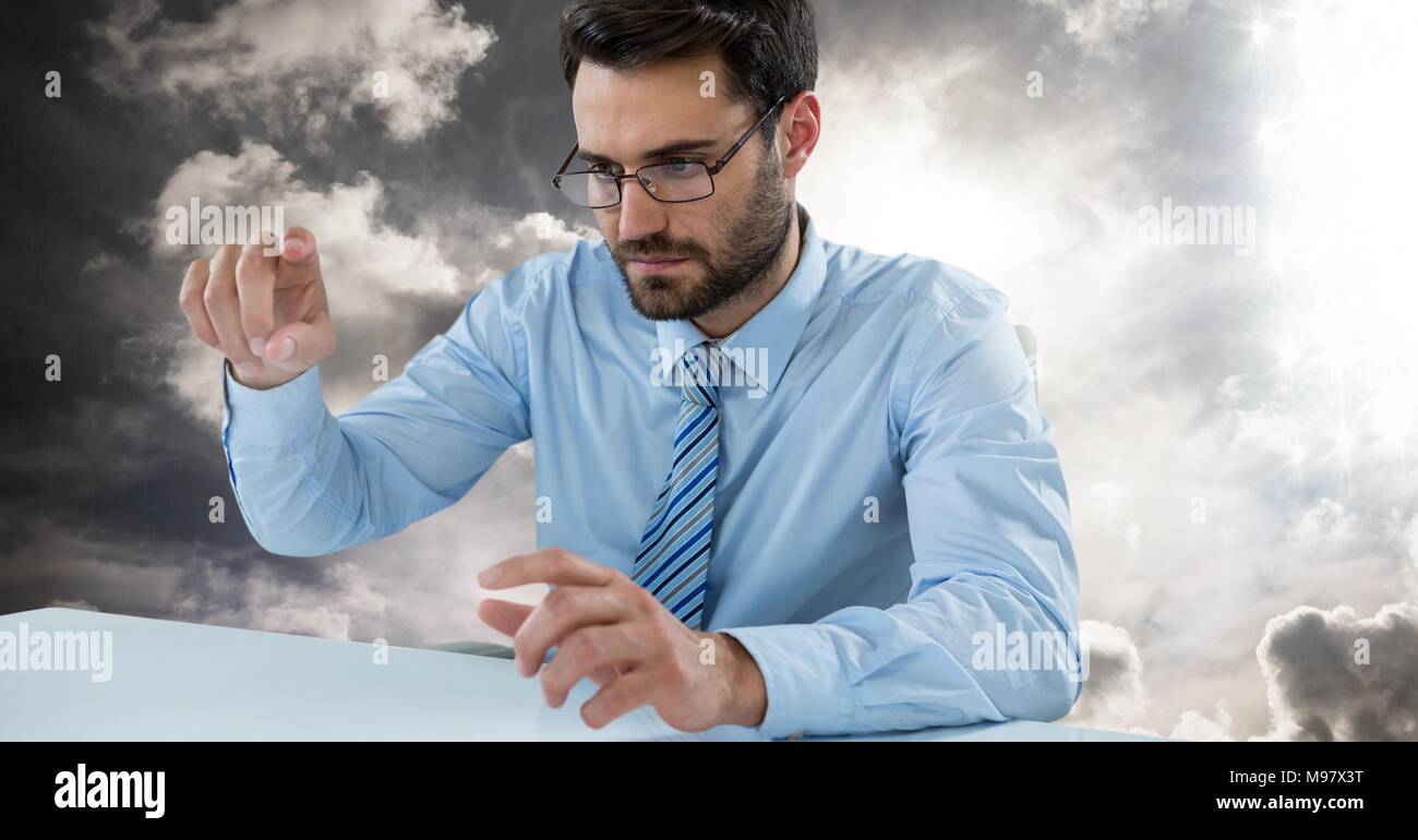 Man touching imaginary object in sky Stock Photo