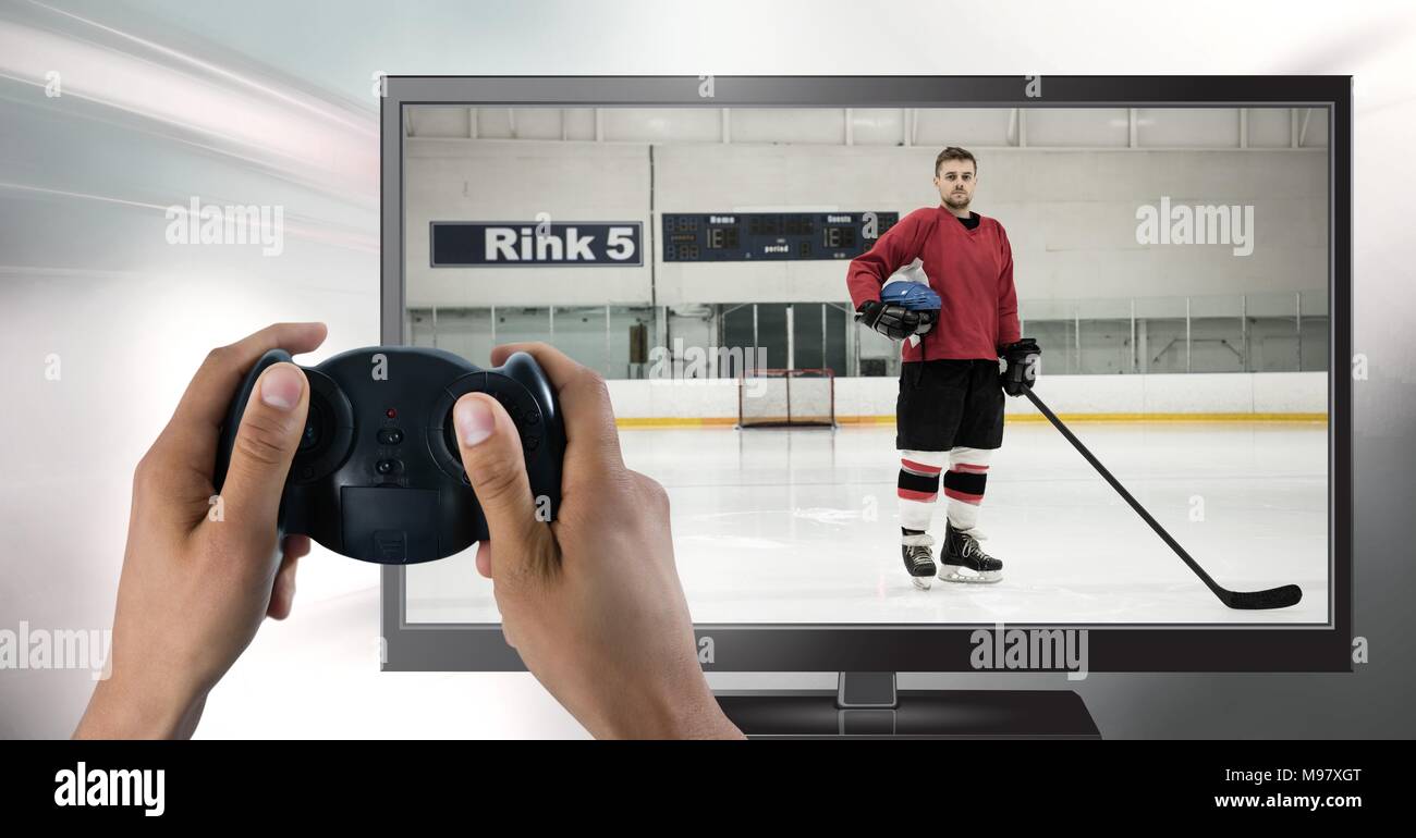 Hands holding gaming controller  with hockey player on television Stock Photo