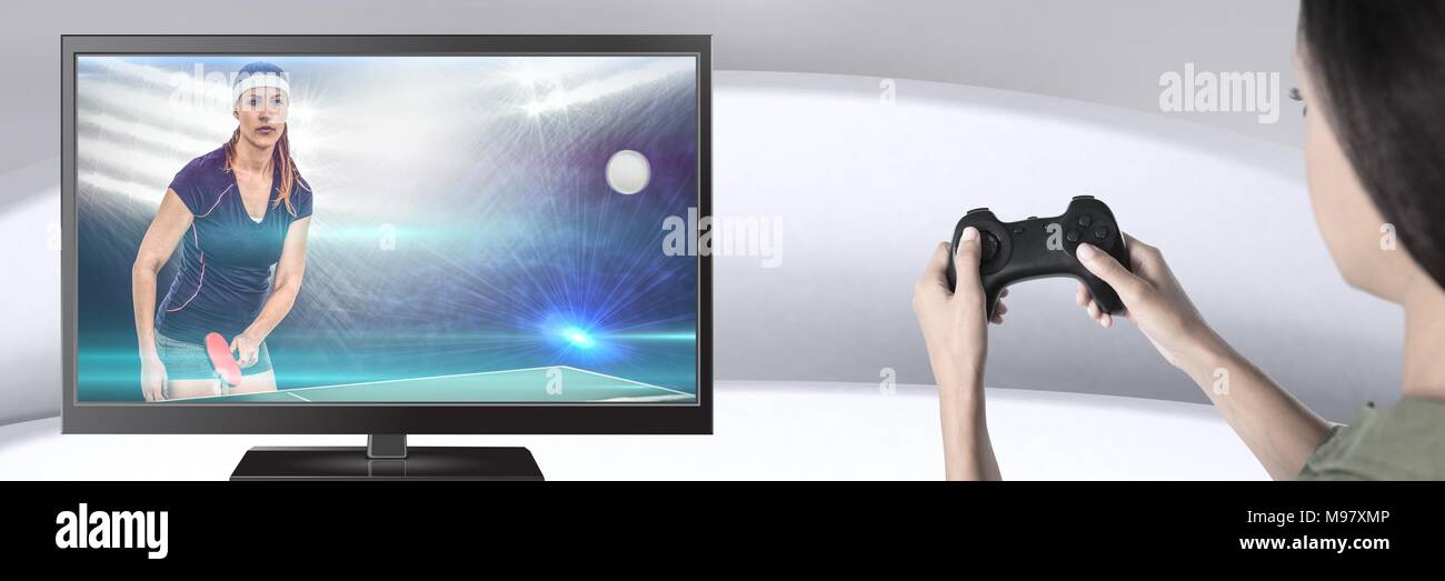 Hands holding gaming controller  with table tennis player on television Stock Photo