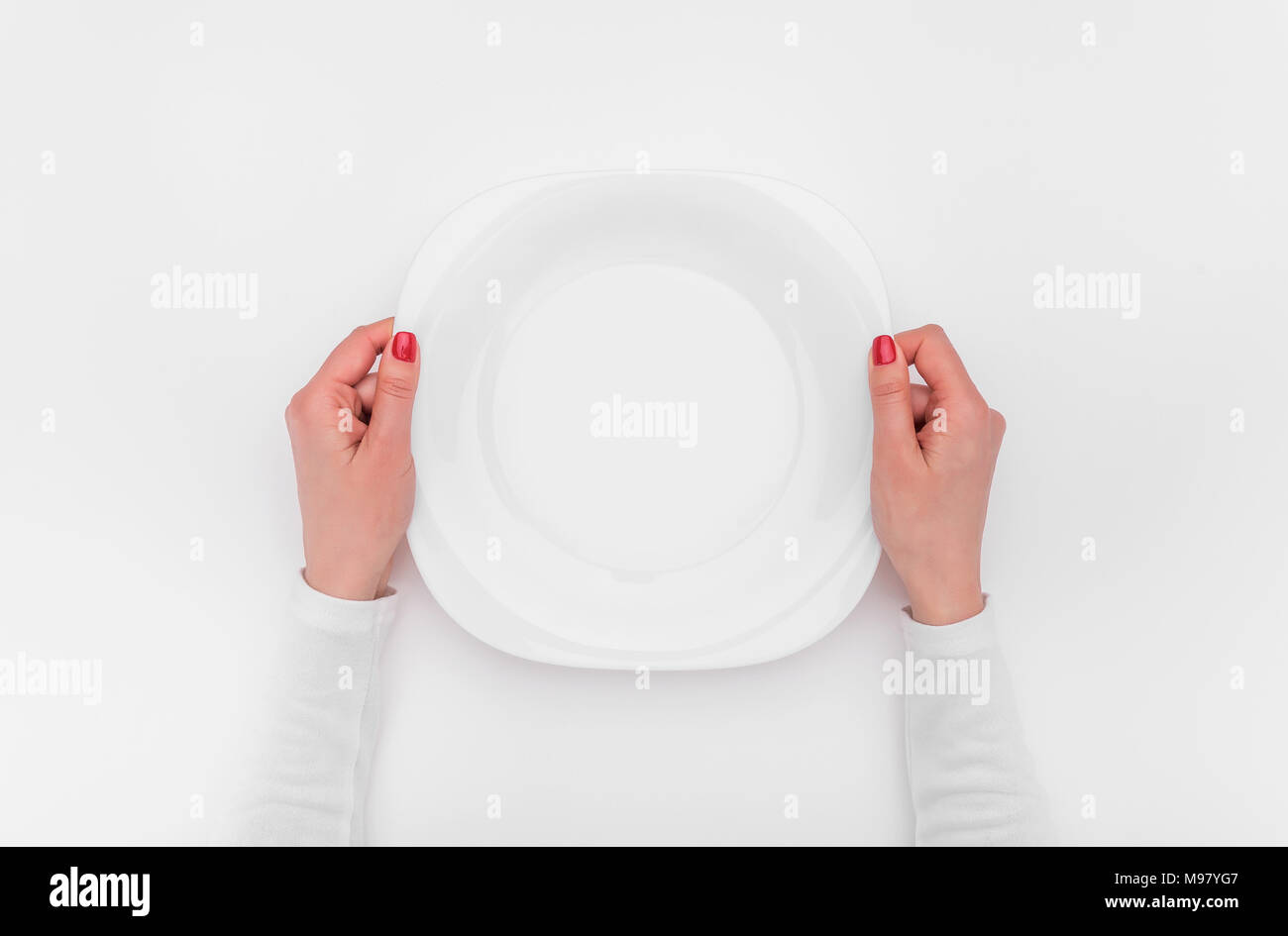 Female hands and an empty plate. Stock Photo