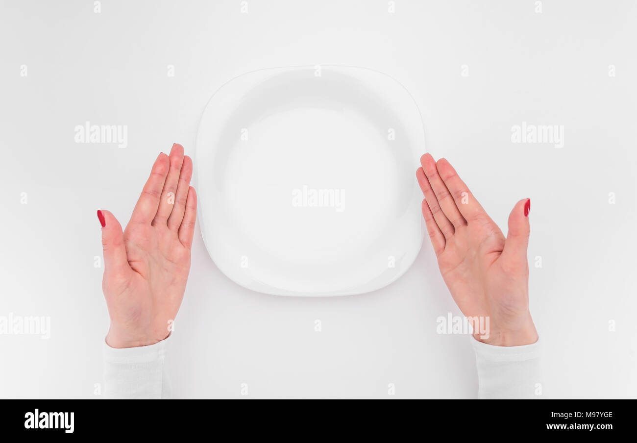 Female hands and an empty plate. Stock Photo