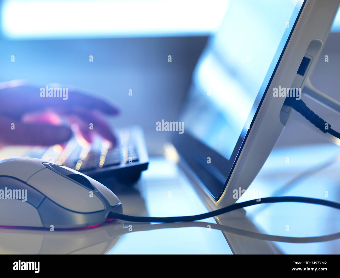 Detail of man working at computer Stock Photo