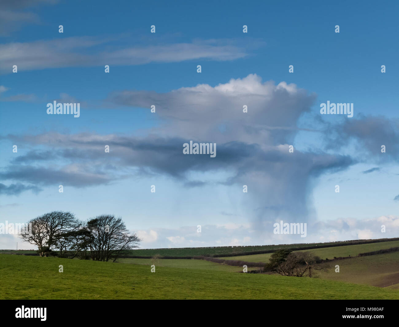 Raincloud and rain shower over Dorset landscape Stock Photo
