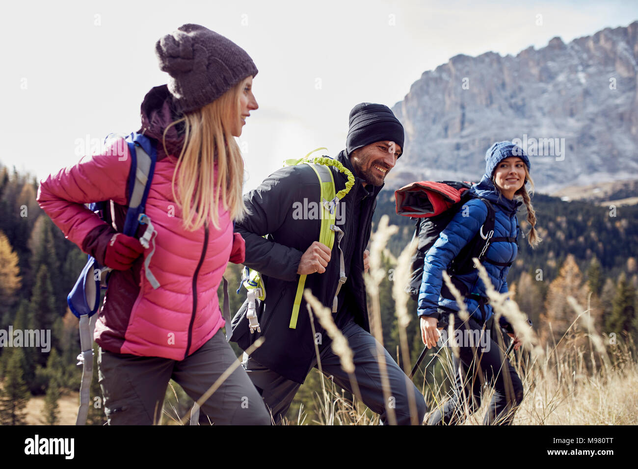 Smiling friends hiking in the mountains Stock Photo