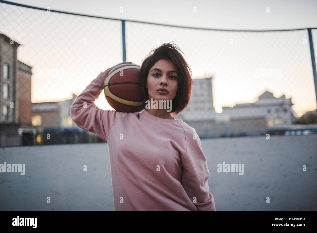 Portrait of young woman holding basketball outdoors Stock Photo - Alamy