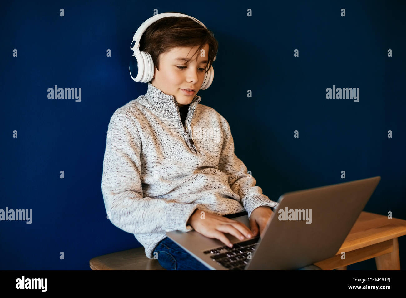 Boy using computer with headphones hi-res stock photography and images ...