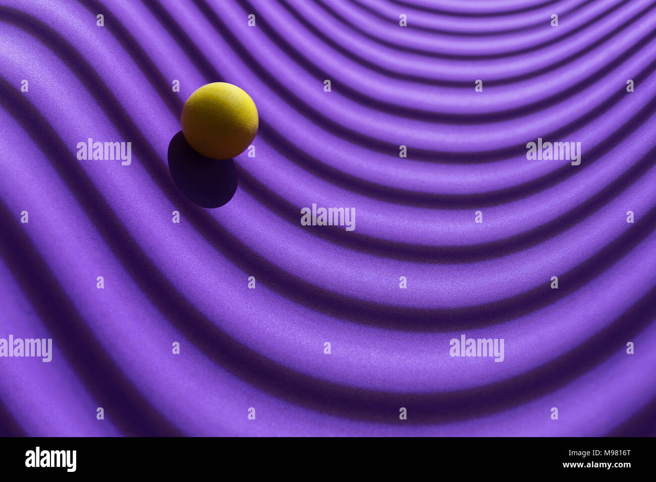 Yellow sphere over a geometric purple background, 3D Rendering Stock Photo