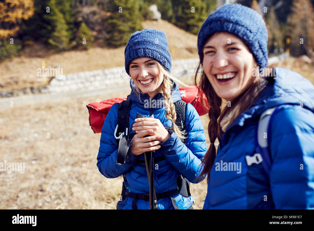 Two laughing young women hiking in the mountains Stock Photo - Alamy