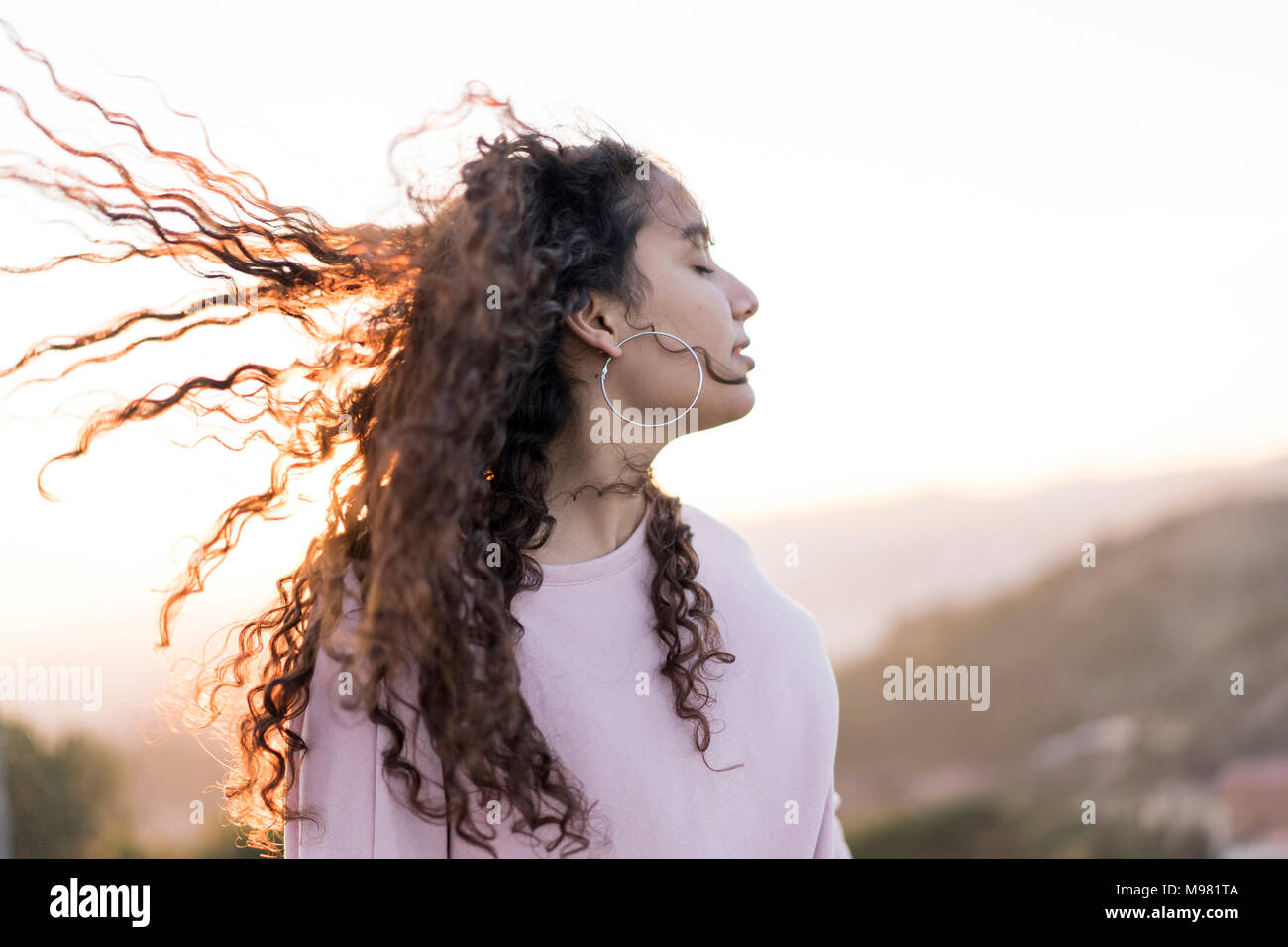 Woman long curly hair blowing hi-res stock photography and images - Alamy