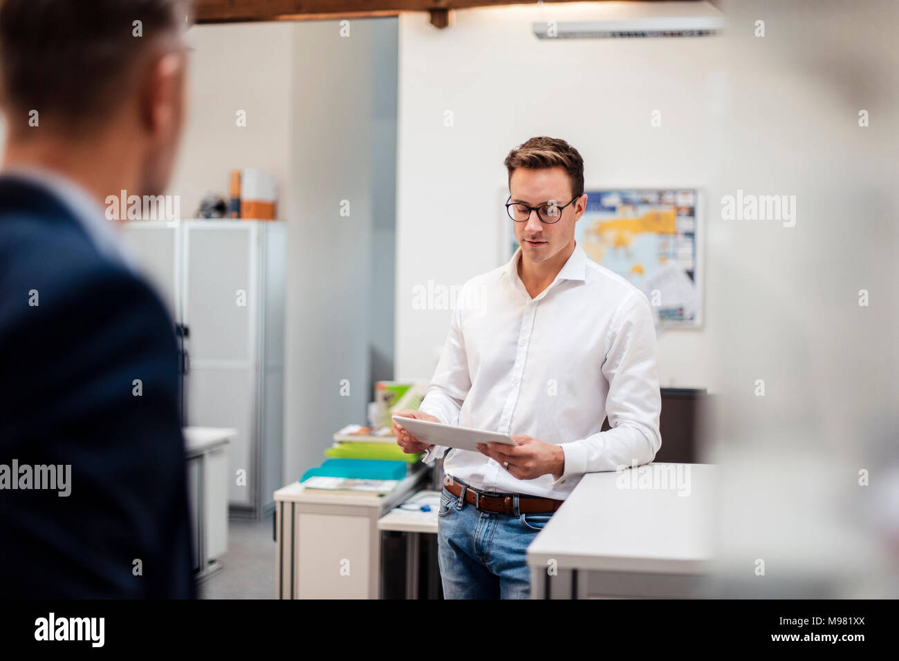 Young businessman using tablet in office Stock Photo