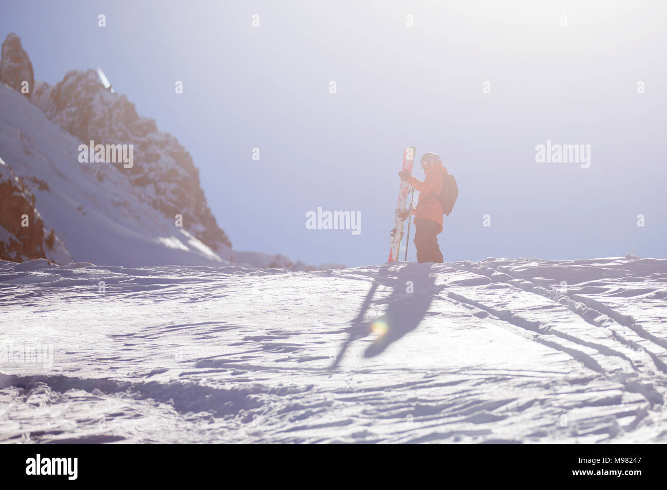 Austria, Tyrol, Mutters, freeride skier ascending mountain Stock Photo