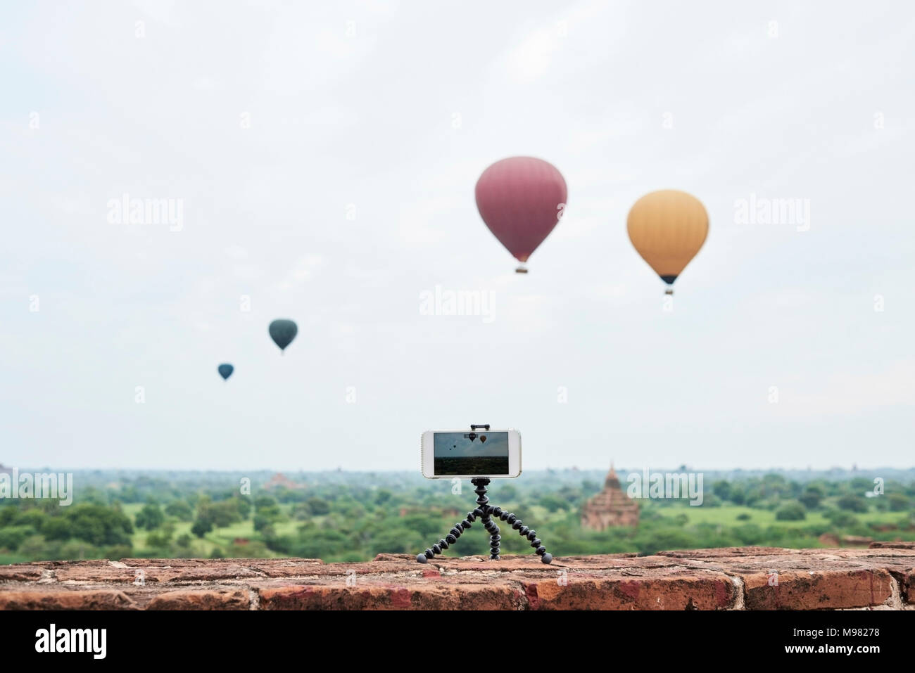 Myanmar, smartphone taking a time lapse of many hot air balloons flying over Bagan Stock Photo