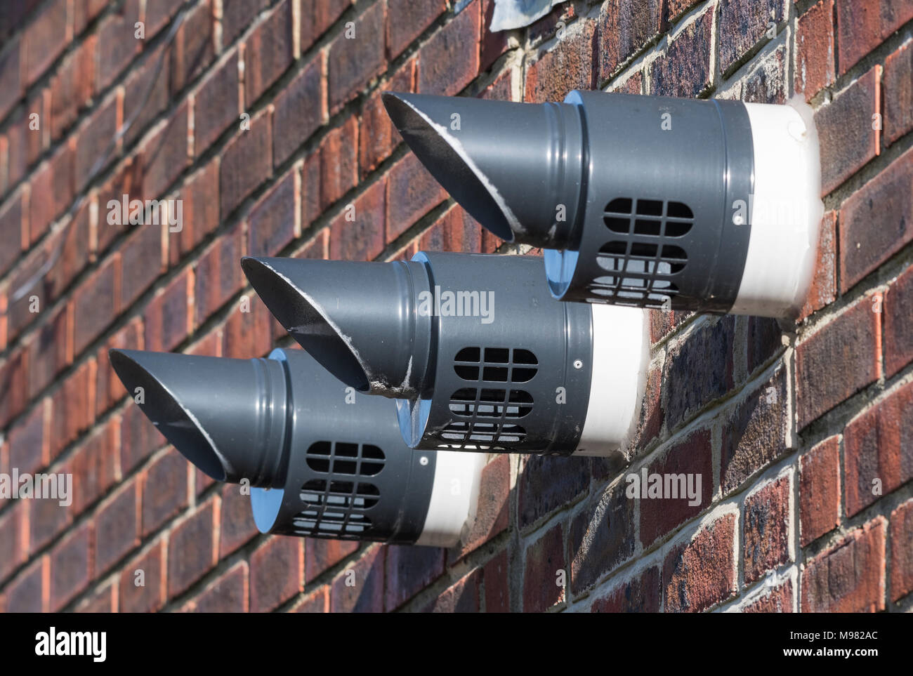Wall mounted appliance ventilation pipes. Extraction pipes. Stock Photo