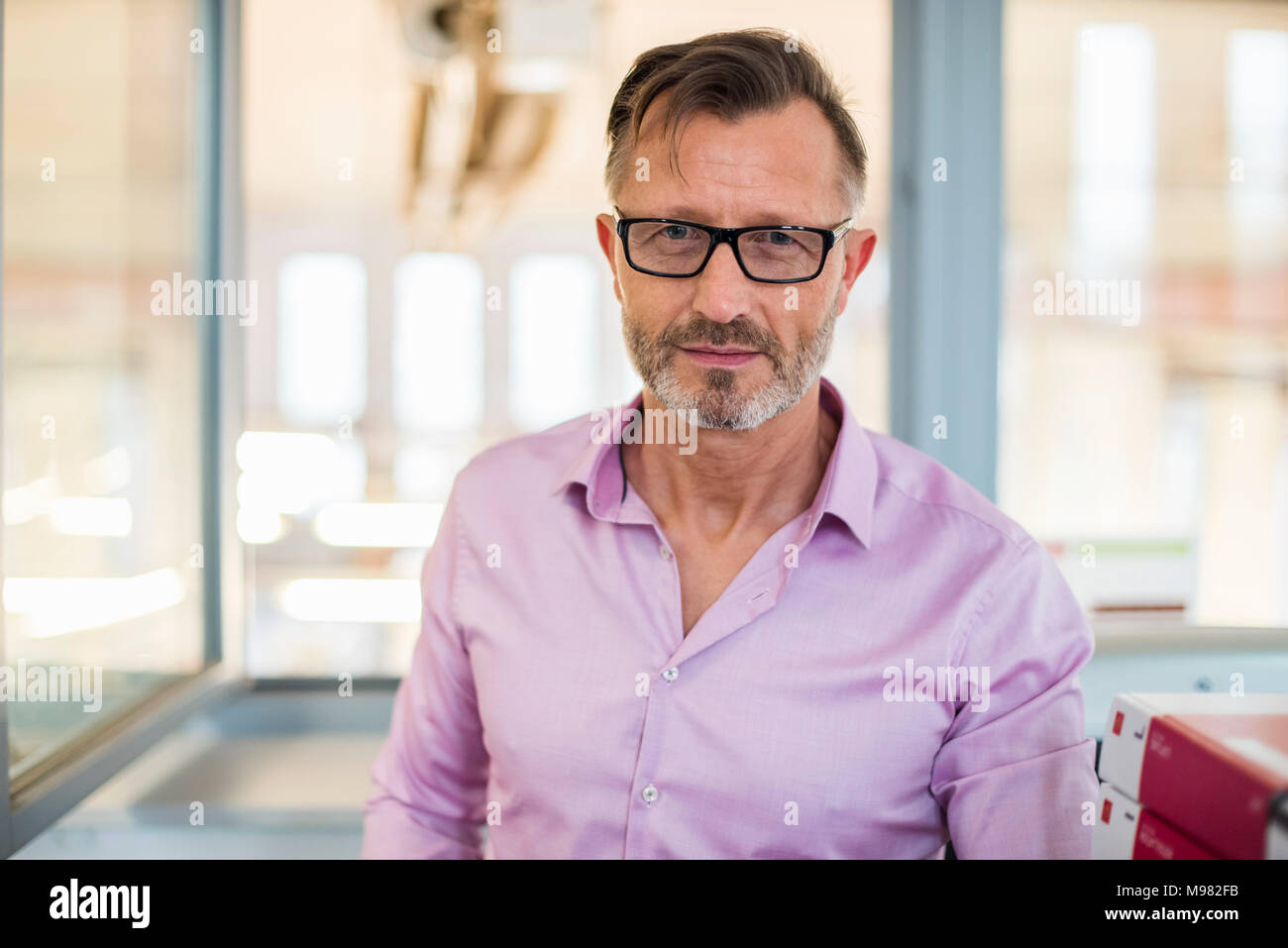 Portrait of confident mature businessman in office Stock Photo
