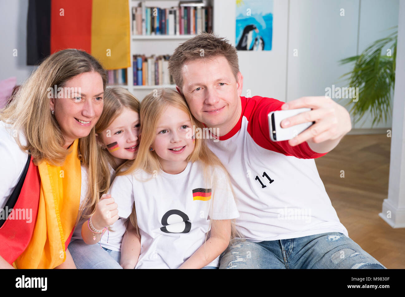 Family watching football world cup, taking a smartphone selfie Stock Photo