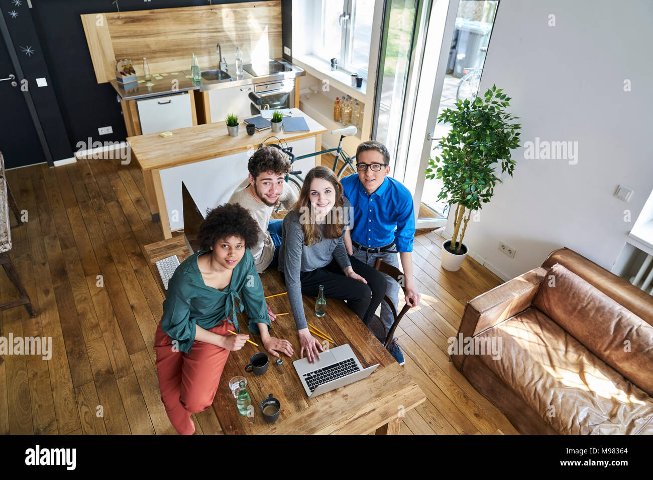 Elevated view of smiling coworkers in office Stock Photo