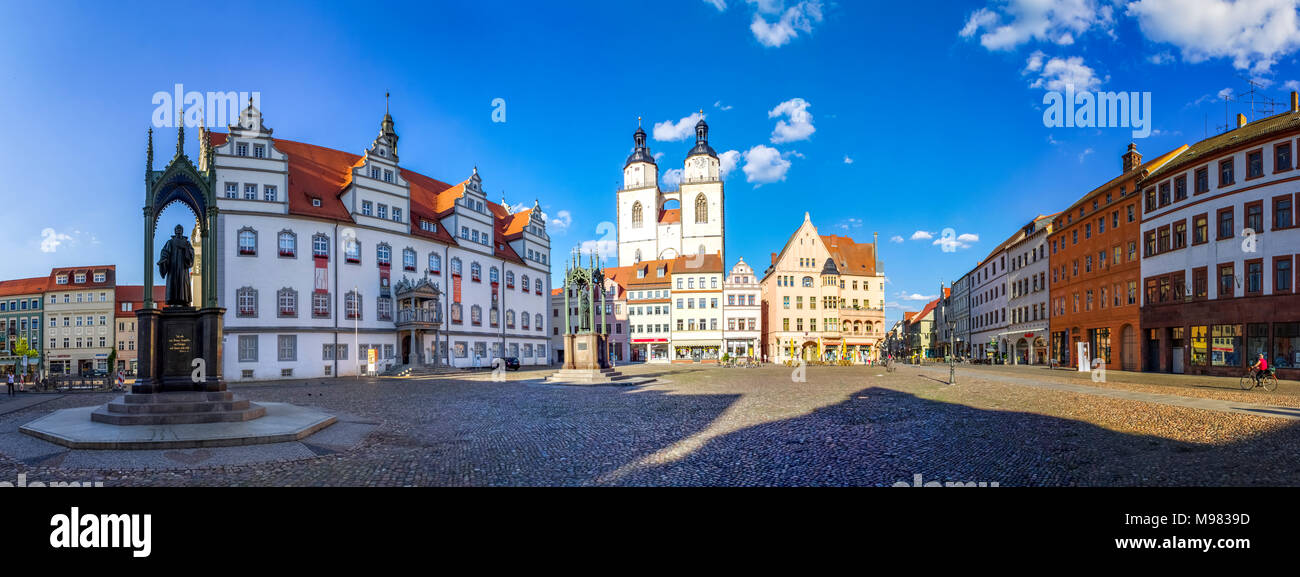 Germany, Lutherstadt Wittenberg, view to town hall, row of houses and St Mary's Church Stock Photo
