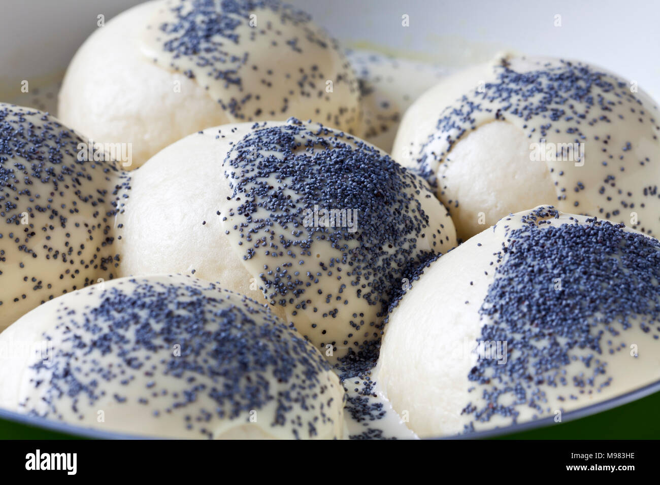 Pan of prepared yeast dumpling in vanilla sauce sprinkled with poppy seed, close-up Stock Photo